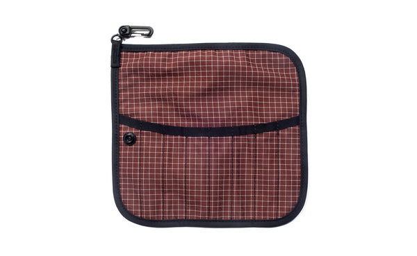 The front of a Tool Pen Wrap in Moab (brick red with white grid) 200 Halcyon.